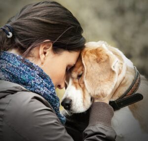 women hugging face of dog