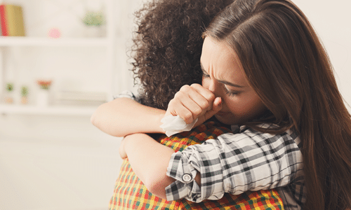 woman grieving and friend comforting the woman